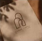 A Qahwa House card with the logo in leaf shadows