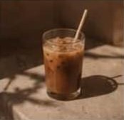 Iced latte in a glass with a paper straw